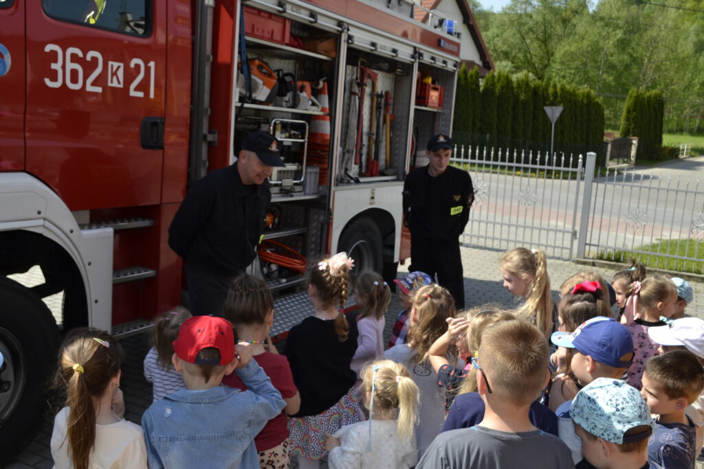strażacy prezentują wóz strażacki przedszkolakom